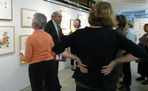 Dick Rauh discusses the paintings at the exhibition.