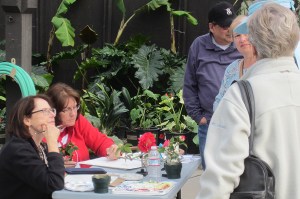 Clara Josephs (left) and Diane Daly (right) discuss botanical art and painting with visitors.