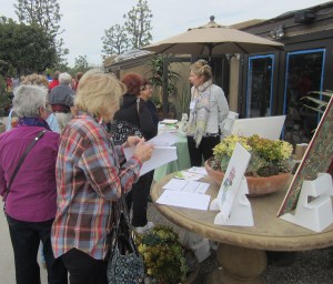 Pat Mark talking with visitors to the BAGSC Botanical Art Information Table. The Information Table also displayed books, originals and prints of contemporary and historical botanical art and scientific illustration. Photo by Peter Conlon.