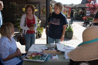 Suzanne Kuuskmae talking with visitors to the BAGSC info table about botanical art. Photo: Linda Carpenter, © 2016, all rights reserved.