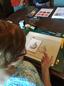 Kathy Morgan demonstrating drawing a pear. Photo by Clara Josephs, © 2016.