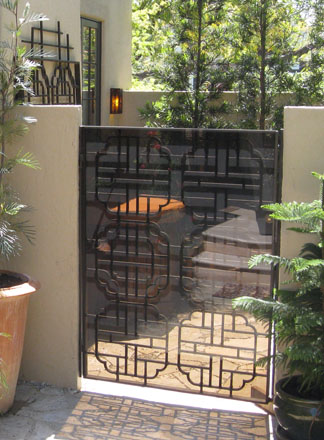 Antique wrought iron gates and several cloud form cast metal panels from a disassembled Chinese pavilion in Bel Air were found on Craigslist and repurposed in the finished landscape as gates and wall pieces. Photo © 2016, Cordelia Donnelly.