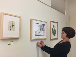 Janice Sharp placing labels throughout the exhibit. Photo by Olga Ryabtsova, © 2017.