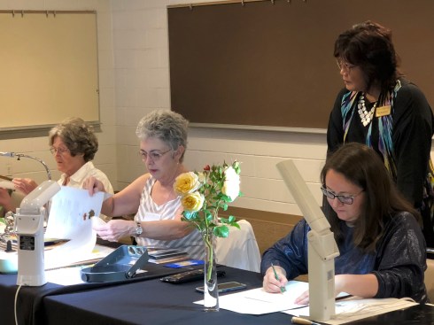 BAGSC members setting up for the botanical art demonstrations. L to R (seated): Estelle DeRidder, Jude Wiesenfeld, Olga Ryabstova; (standing) Teri Kuwahara.