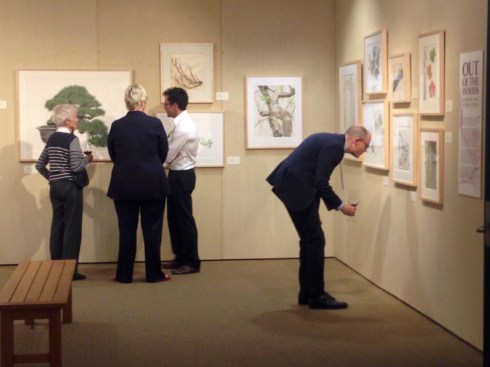 Guests enjoying the "Out of the Woods" exhibition.