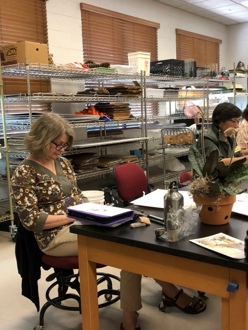 Carol Woodin reviewing her notes before her presentation about orchids. Carol discussed what she looked for in an orchid subject, as well as composition issues that orchids may present.