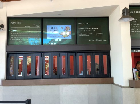 Digital signage above the ticket booths at the front entrance.
